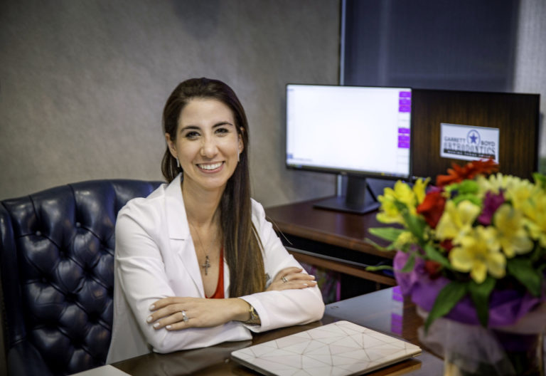 Dr. Carina Perez-Cisneros sitting at desk in Garrett & Boyd Orthodontics office