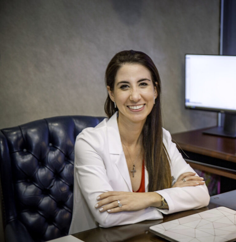 Dr. Carina Perez-Cisneros sitting at desk in Garrett & Boyd Orthodontics office