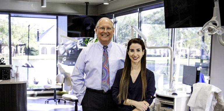 Dr. Richard W. Boyd and Dr. Carina Perez-Cisneros standing in Garrett & Boyd Orthodontics office - wide shot